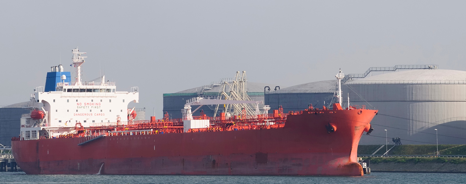 Cargo ship near oil storage